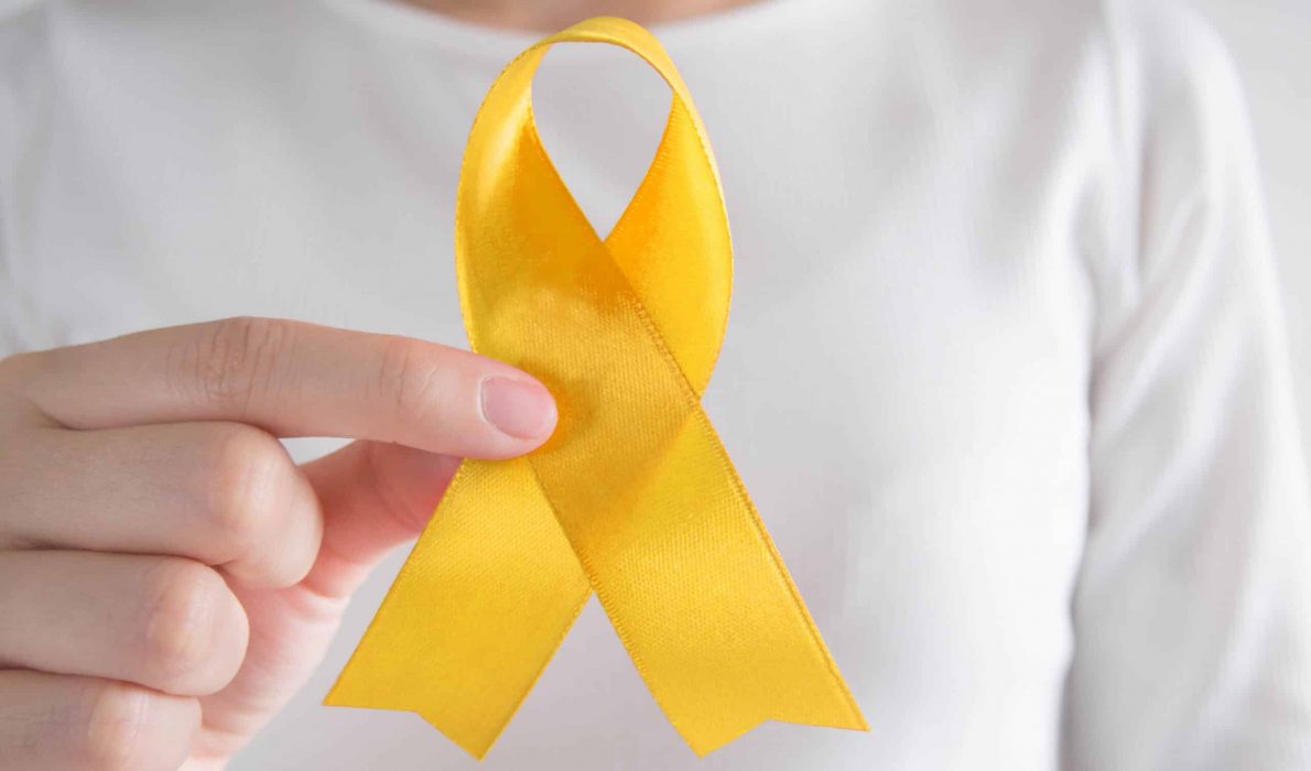 Woman holding a yellow ribbon